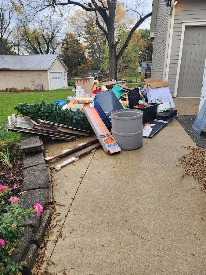 Dumpster being loaded with debris for Residential Dumpster Rental in Castleton